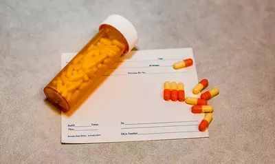 bottle and pills on top of prescription