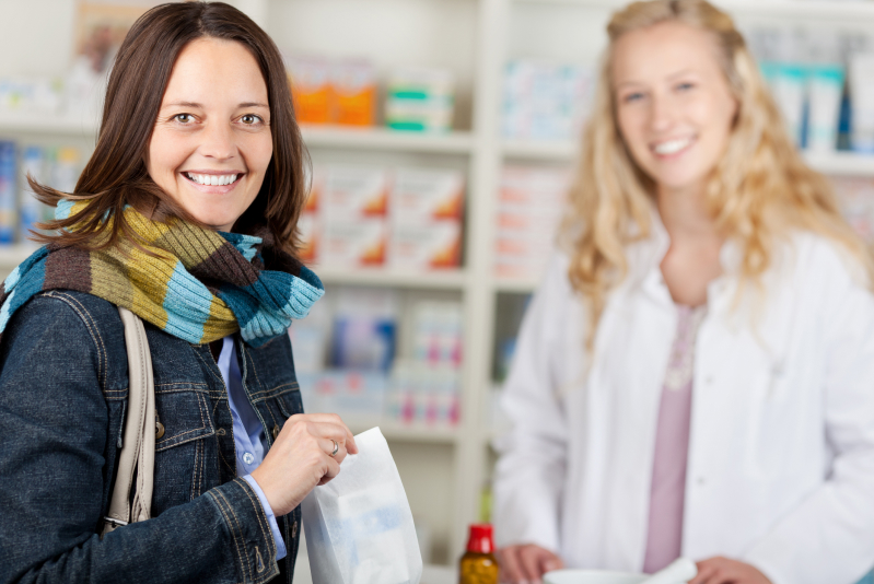 smiling customer and pharmacist after transaction