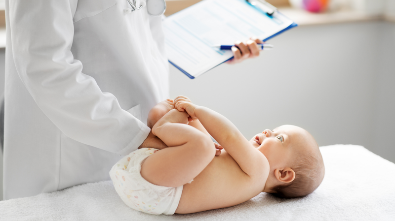 doctor examining baby at pediatrician appointment