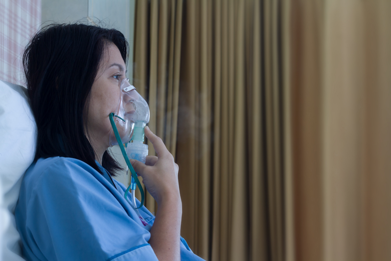 woman breathing from a nebulizer