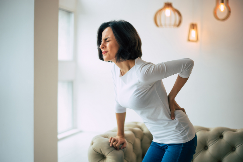 woman holding back in pain