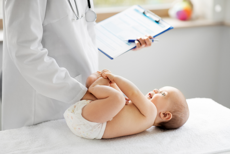 doctor examining baby at pediatrician appointment